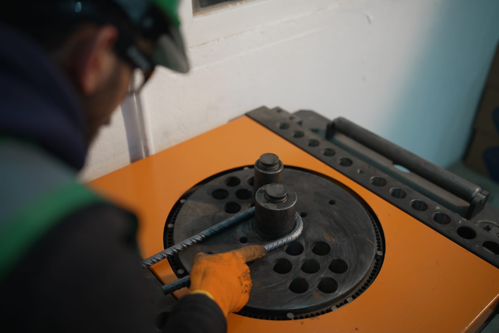 Technician bending a rebar sample for mechanical testing